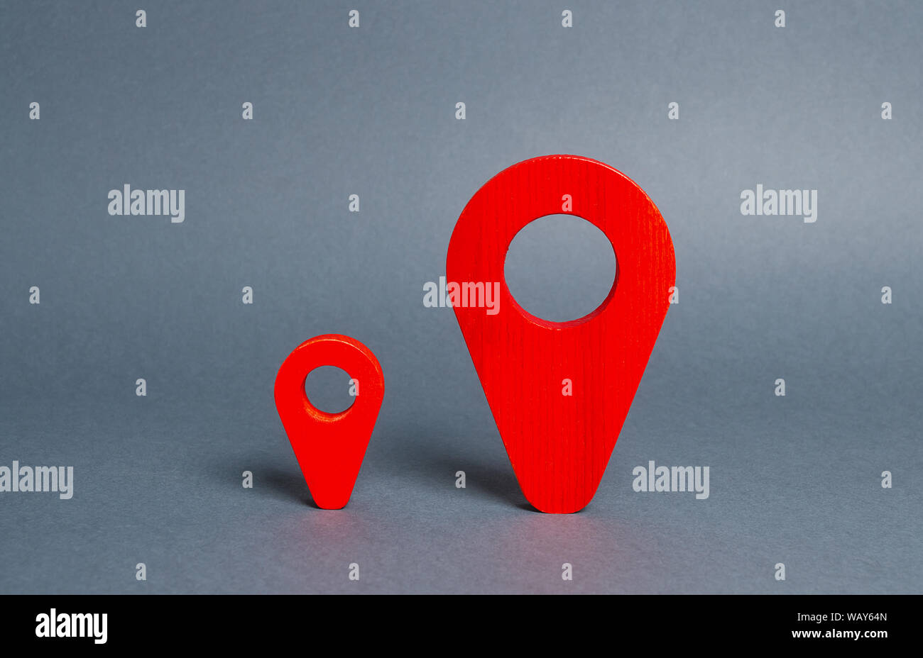 Small and large red navigational location indicators. The concept of a