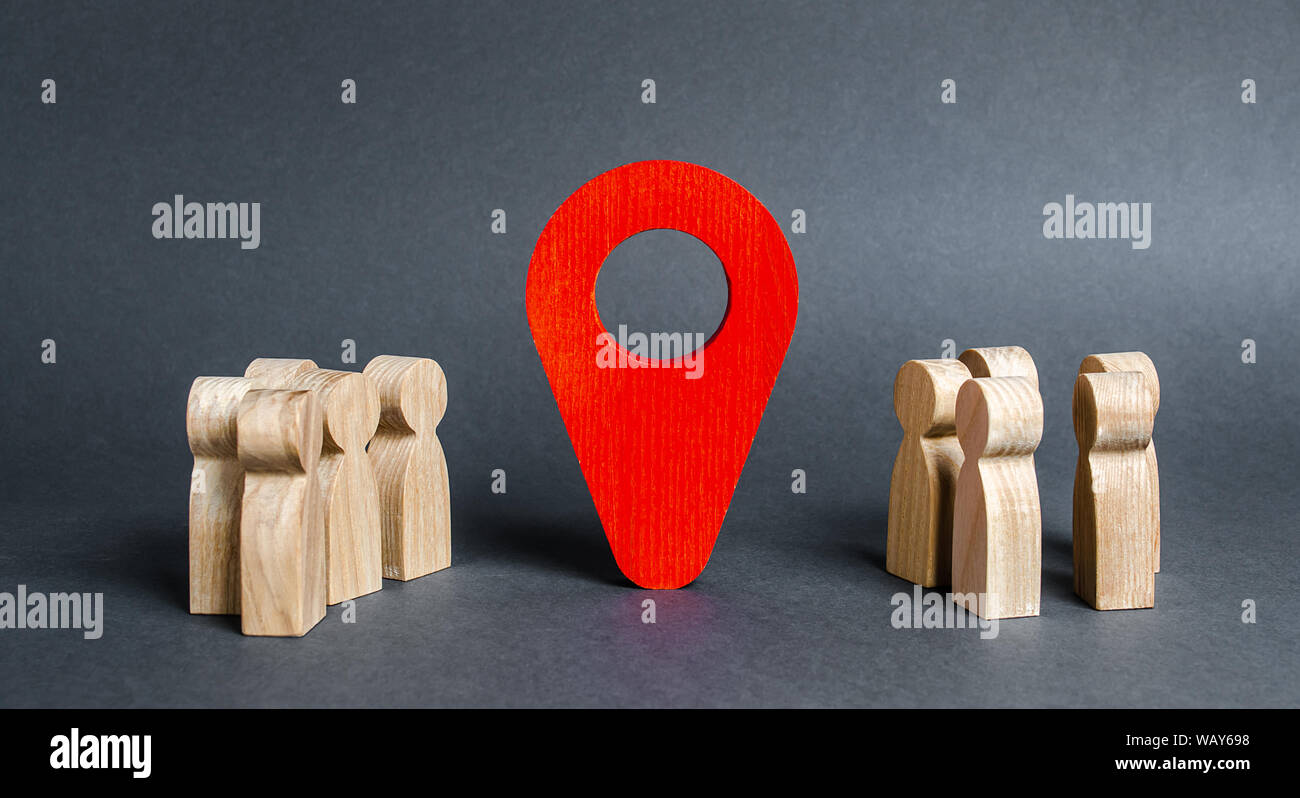 Two groups of people are divided by a red location indicator. Meeting place concept. acquaintance via the Internet. Event or holiday. joint trip. Attr Stock Photo