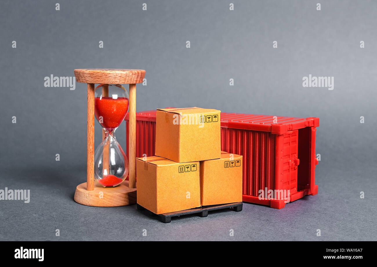 Red container with cardboard boxes and an hourglass. Express delivery in short time concept. Temporary storage, limited offer and discount. Optimizati Stock Photo