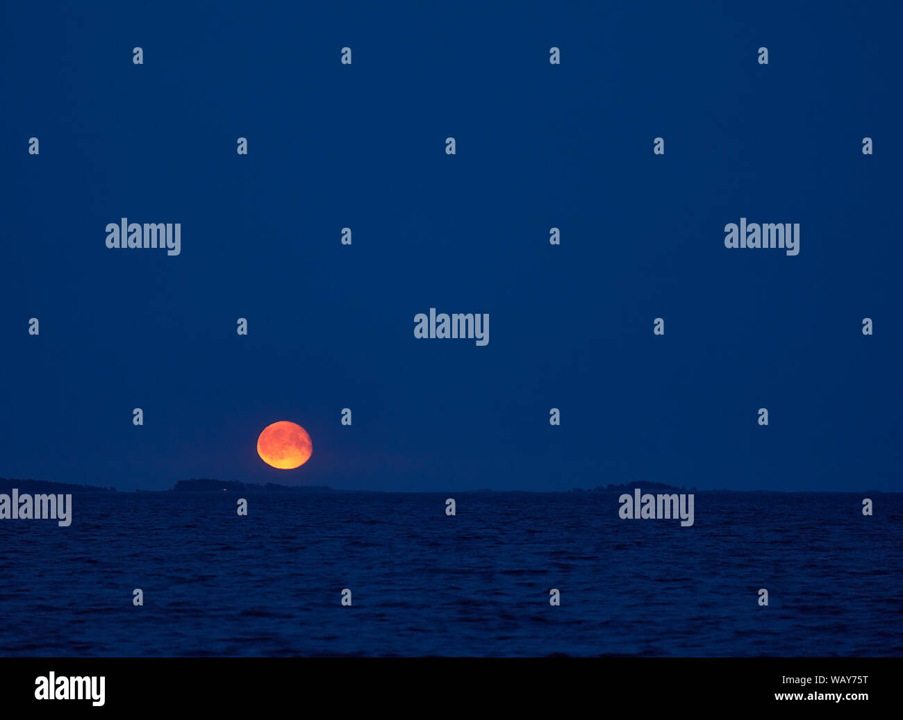 Moonrise over Baltic Sea in Southern Finland on early summer night in August Stock Photo