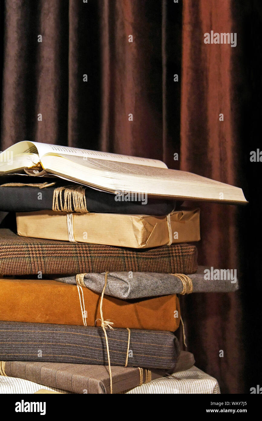 Stack of books packed in recycled wrapping Stock Photo Alamy