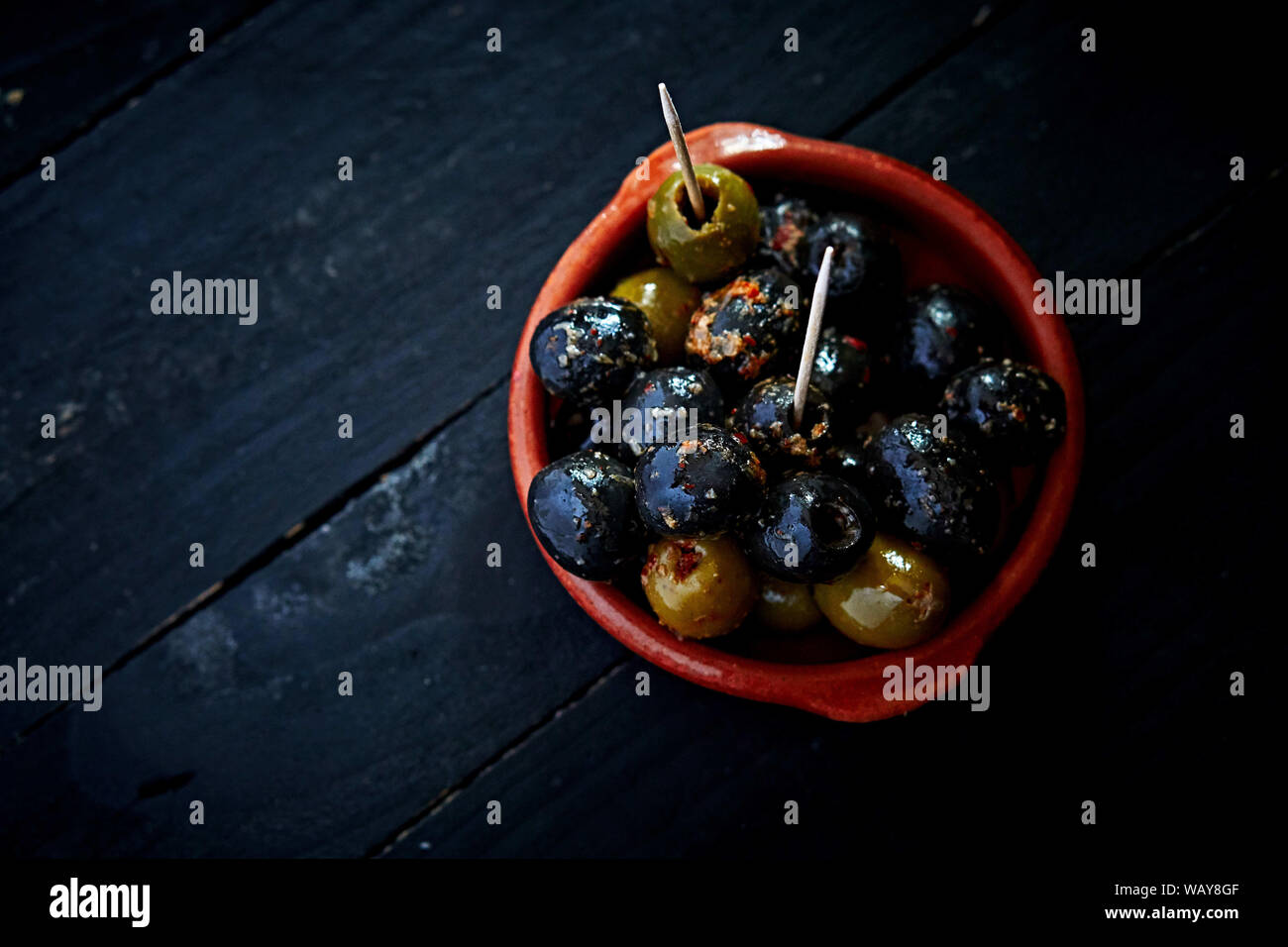 Olives from above in a Tapas-Cup at a Tapas restaurant Stock Photo