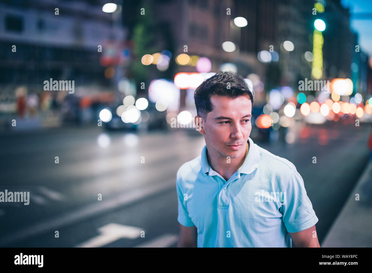 A young man posing at night in city center Stock Photo - Alamy