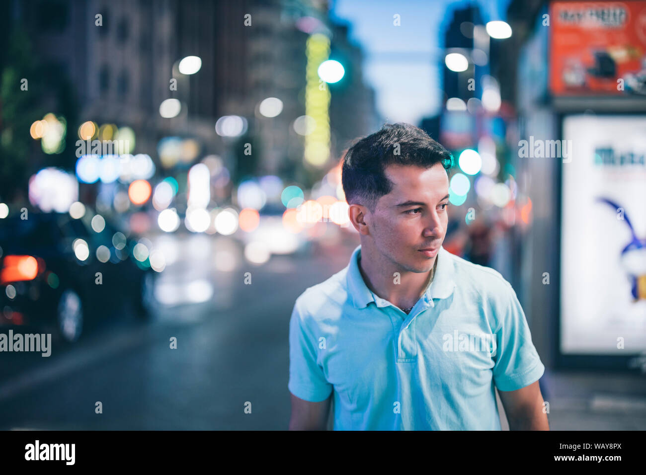 A young man posing at night in city center Stock Photo - Alamy