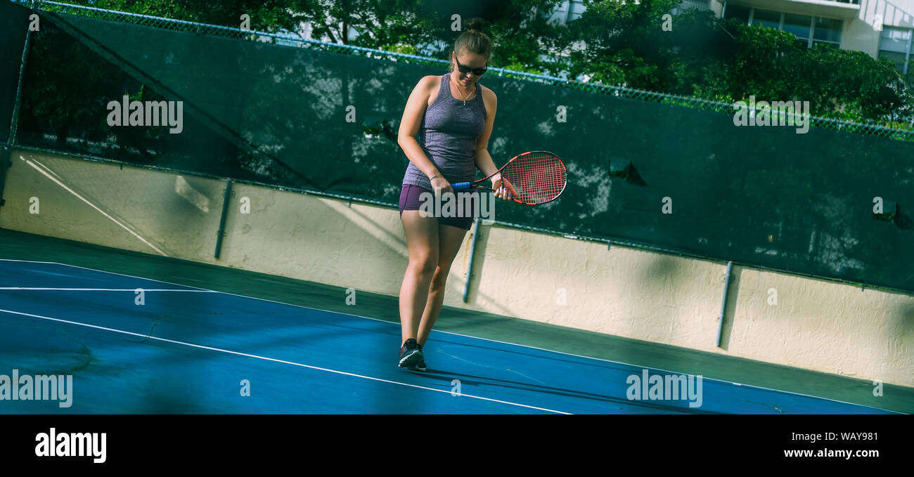 Women's single tennis game. Stock Photo