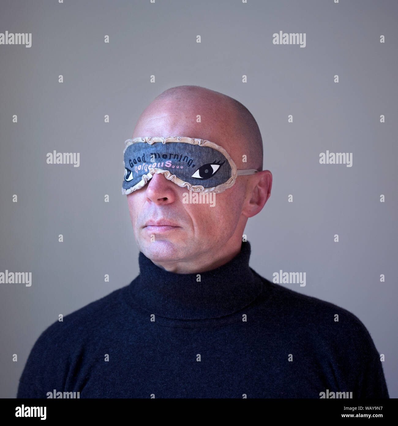 Head and Shoulders Portrait of Man Wearing Eye Mask Stock Photo