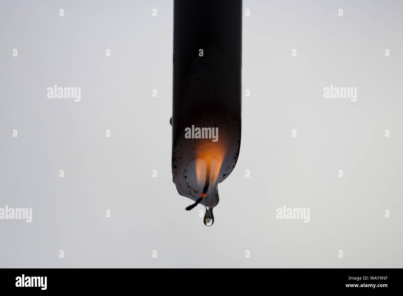 Burning Candle Upside Down Stock Photo