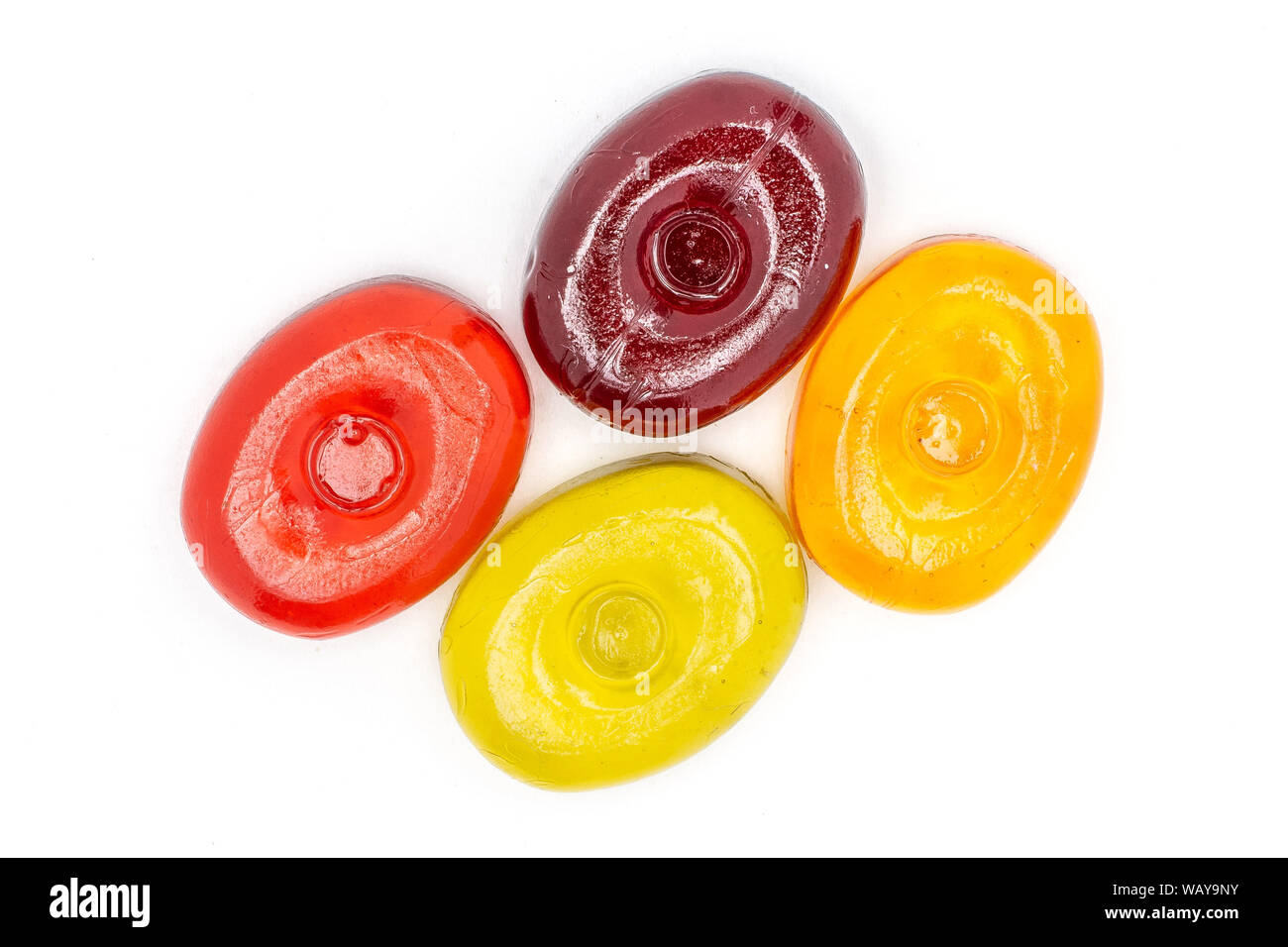 Group of four whole colourful hard candy flatlay isolated on white ...
