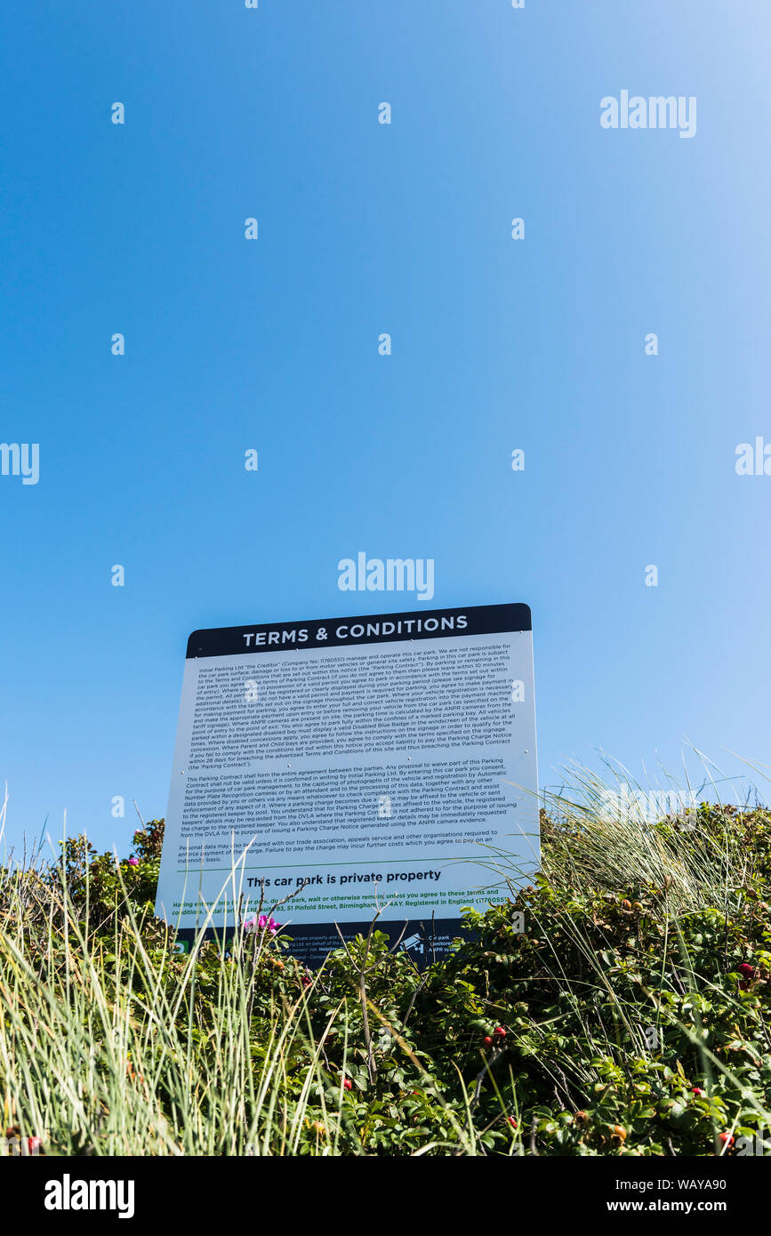 A noticeboard with the terms and conditions for parking at Fistral car