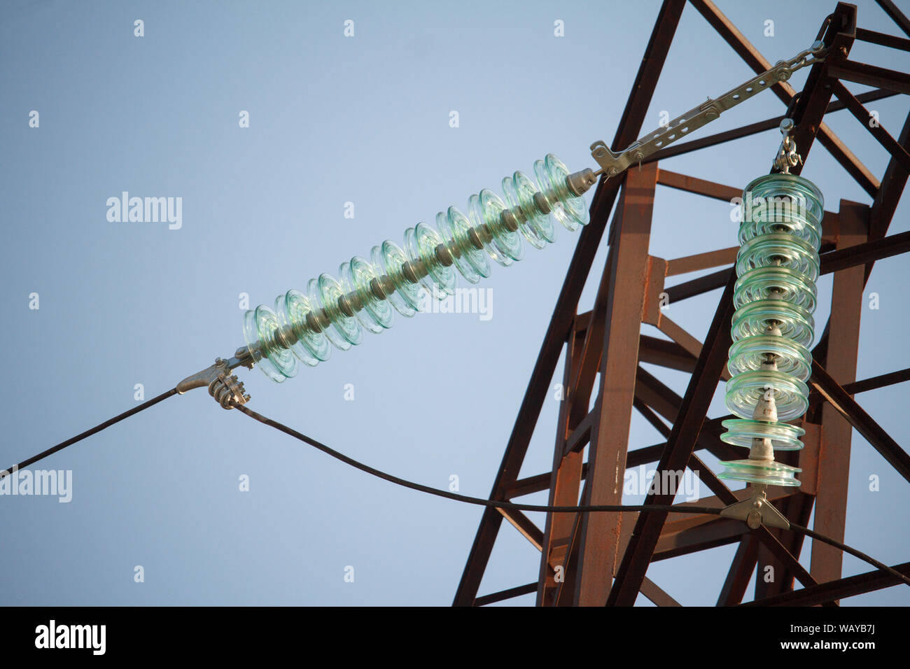Close up bottom view of insulators on high-voltage wires on a power ...