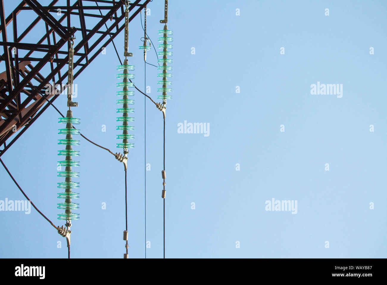 Close up bottom view of insulators on high-voltage wires on a power ...
