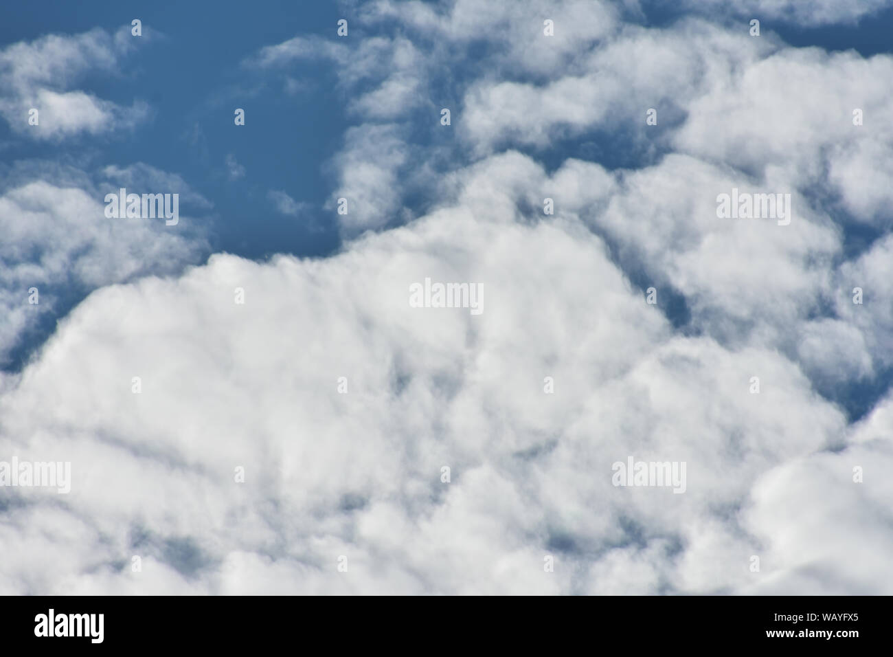 White clouds with blue sky breaking through. Stock Photo