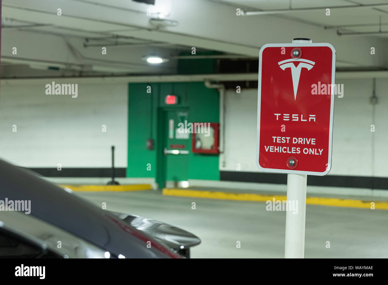 'Tesla Test Test Drive Vehicle Only' sign behind parked Tesla Model X in the underground parking lot below the Tesla Store at Yorkdale Shopping Centre Stock Photo