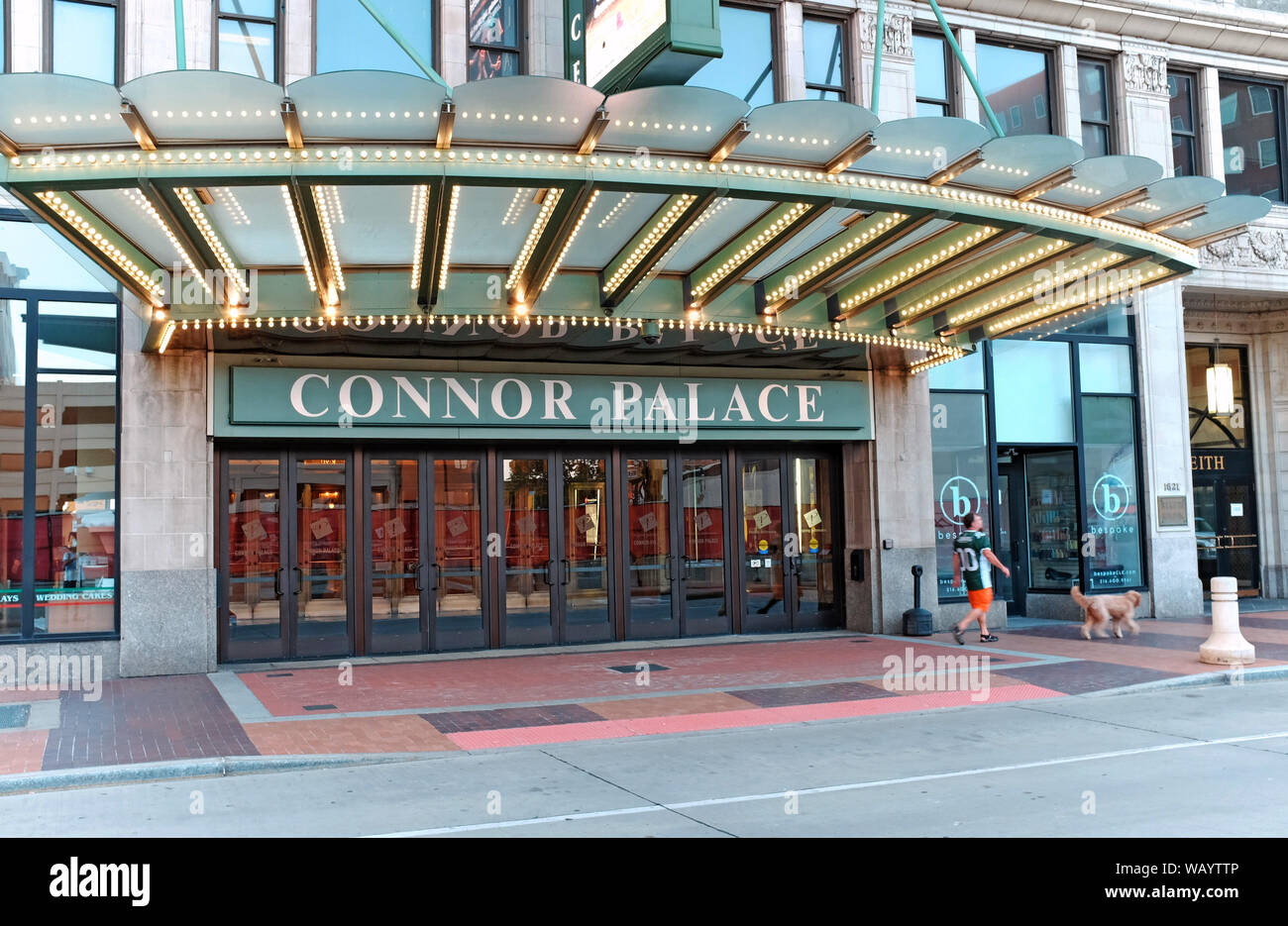 A man walks his dog past the Connor Palace theater in the Playhouse Square  performing arts district of downtown Cleveland, Ohio, USA Stock Photo -  Alamy
