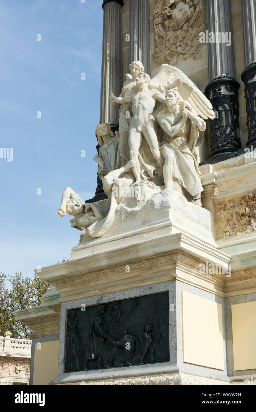 MADRID, SPAIN - APRIL 23, 2018: One of the group of sculptures at the side of the main pillar of the Monument to the King Alfonso XII in the Retiro Pa Stock Photo