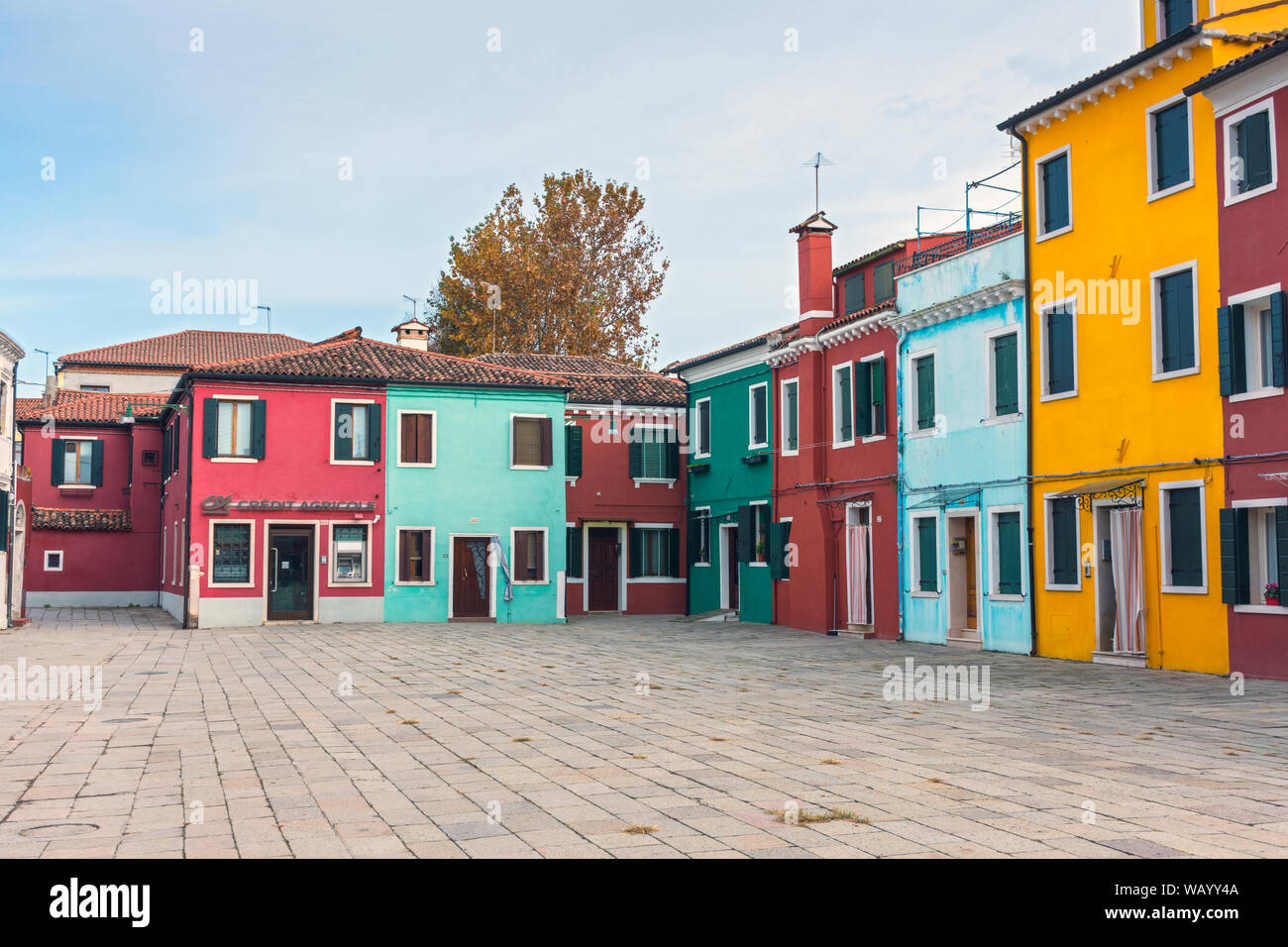 Brightly coloured buildings at the Piazza Baldassare Galuppi, Burano, Laguna Veneto, Italy Stock Photo