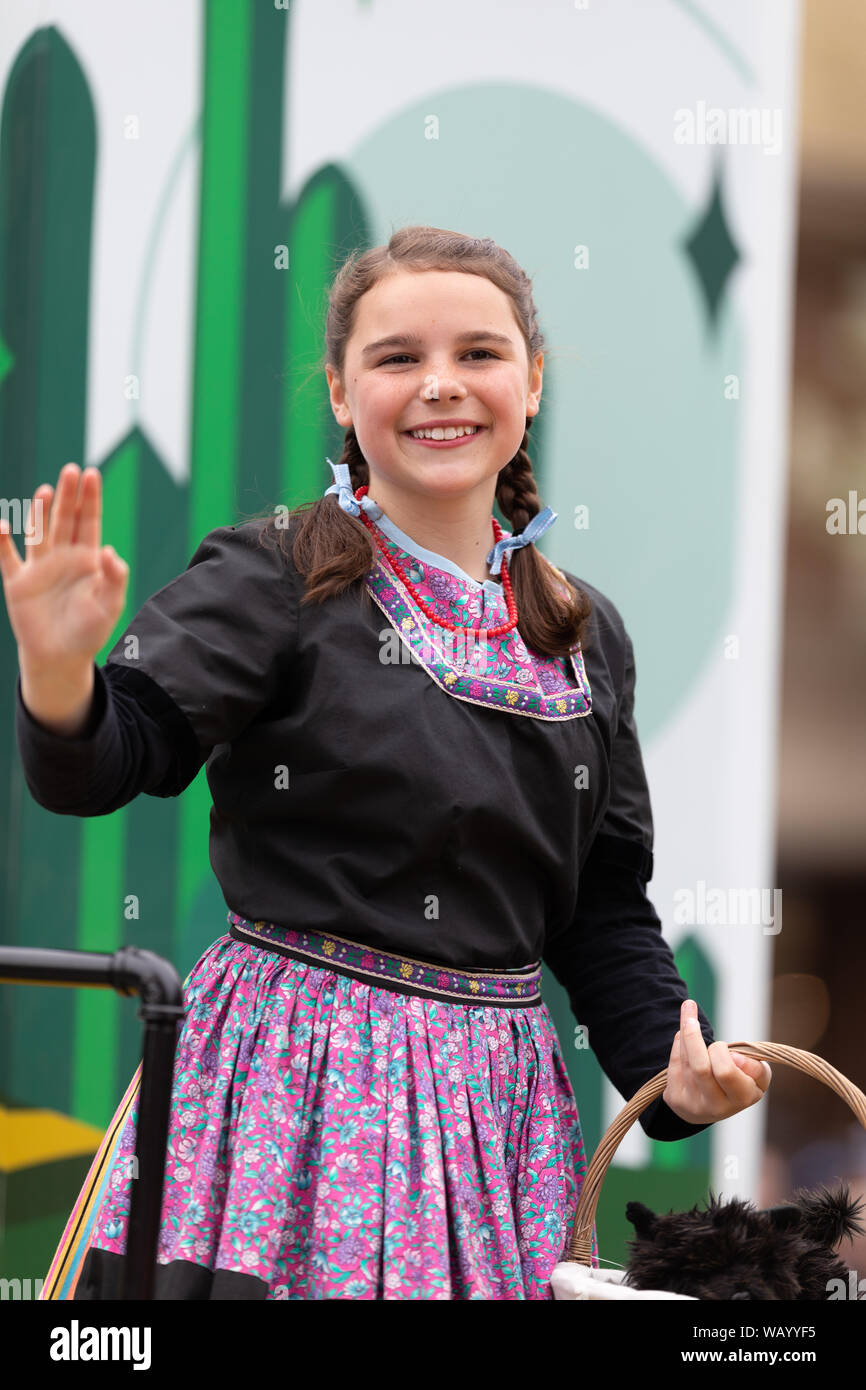Holland, Michigan, USA - May 11, 2019: Tulip Time Parade, Young woman dress up as Dorothy from the Wizard of Oz, Smiling and waving at people during t Stock Photo