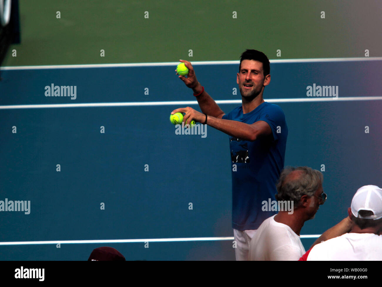 Flushing Meadows, New York, United States - 21 August 2019. Novak Djokovic of Serbia throws some balls to fans in the stands after practicing at the National Tennis Center in Flushing Meadows, New York in preparation for the US Open which begins next Monday. Credit: Adam Stoltman/Alamy Live News Stock Photo