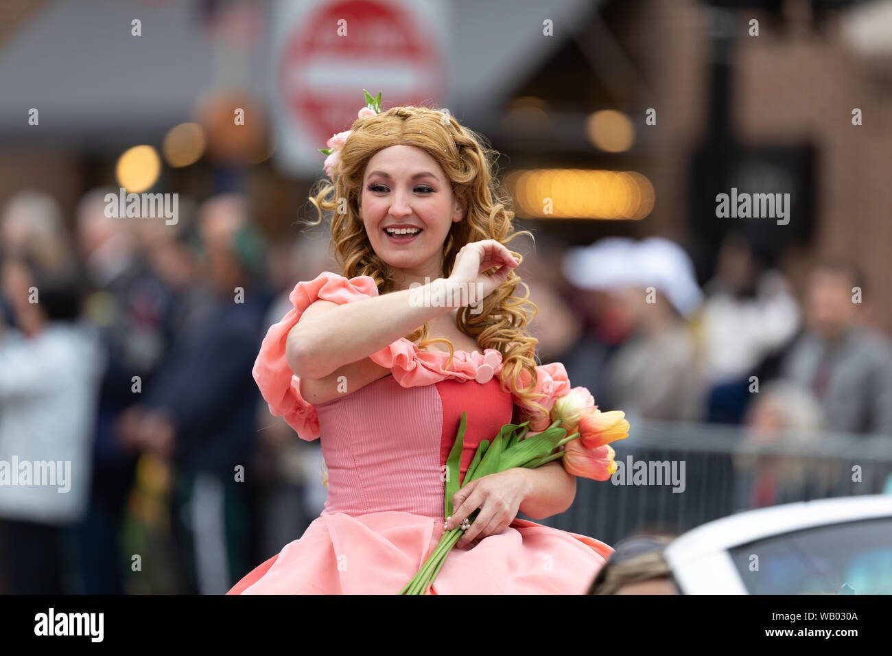 Holland, Michigan, USA - May 11, 2019: Tulip Time Parade, Woman dress up as Disney Character Aurora during the parade Stock Photo
