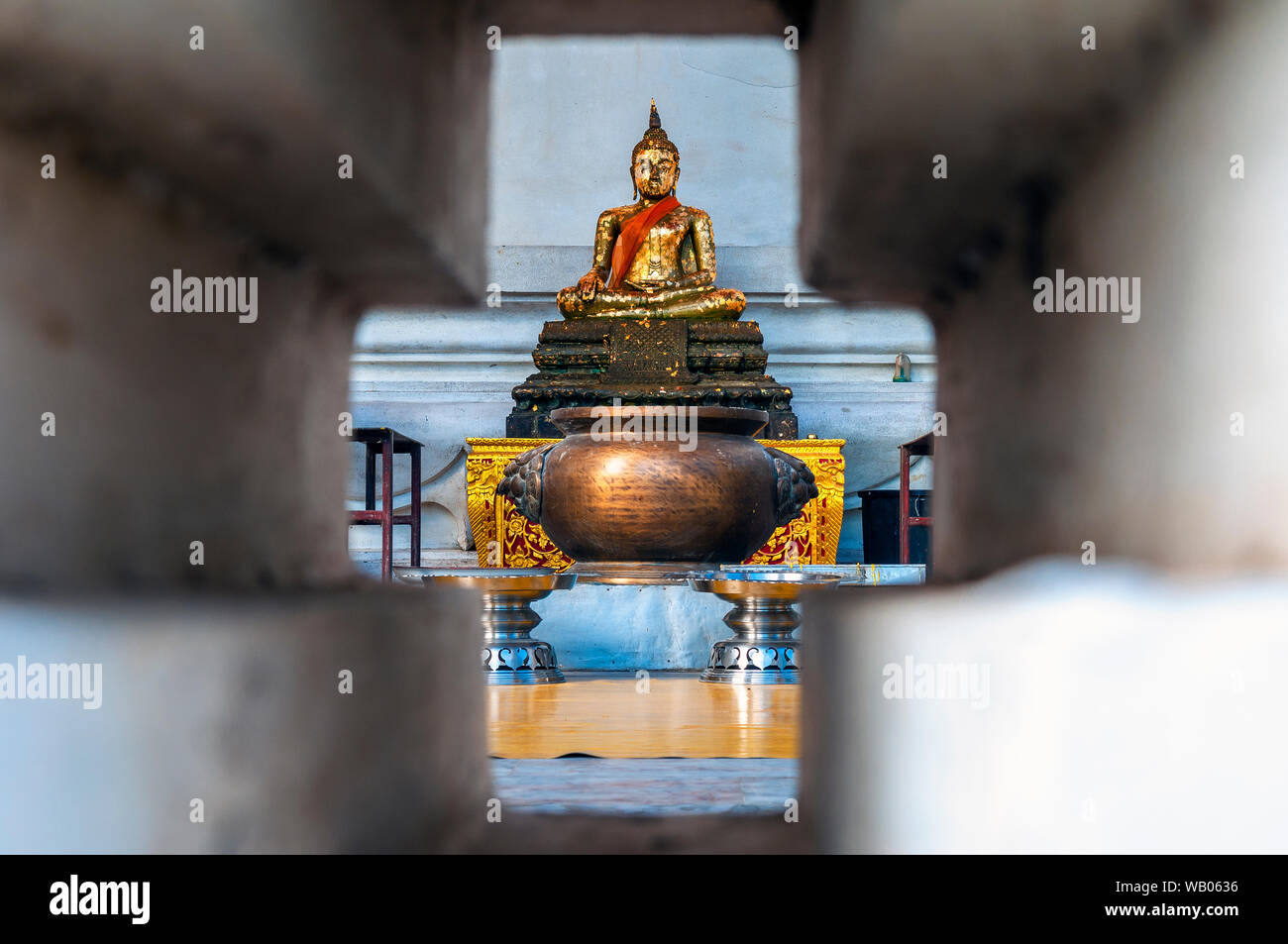 Perspective of a buddha statue in meditation position and covered with gold leaves, Ayutthaya, Thailand. Stock Photo