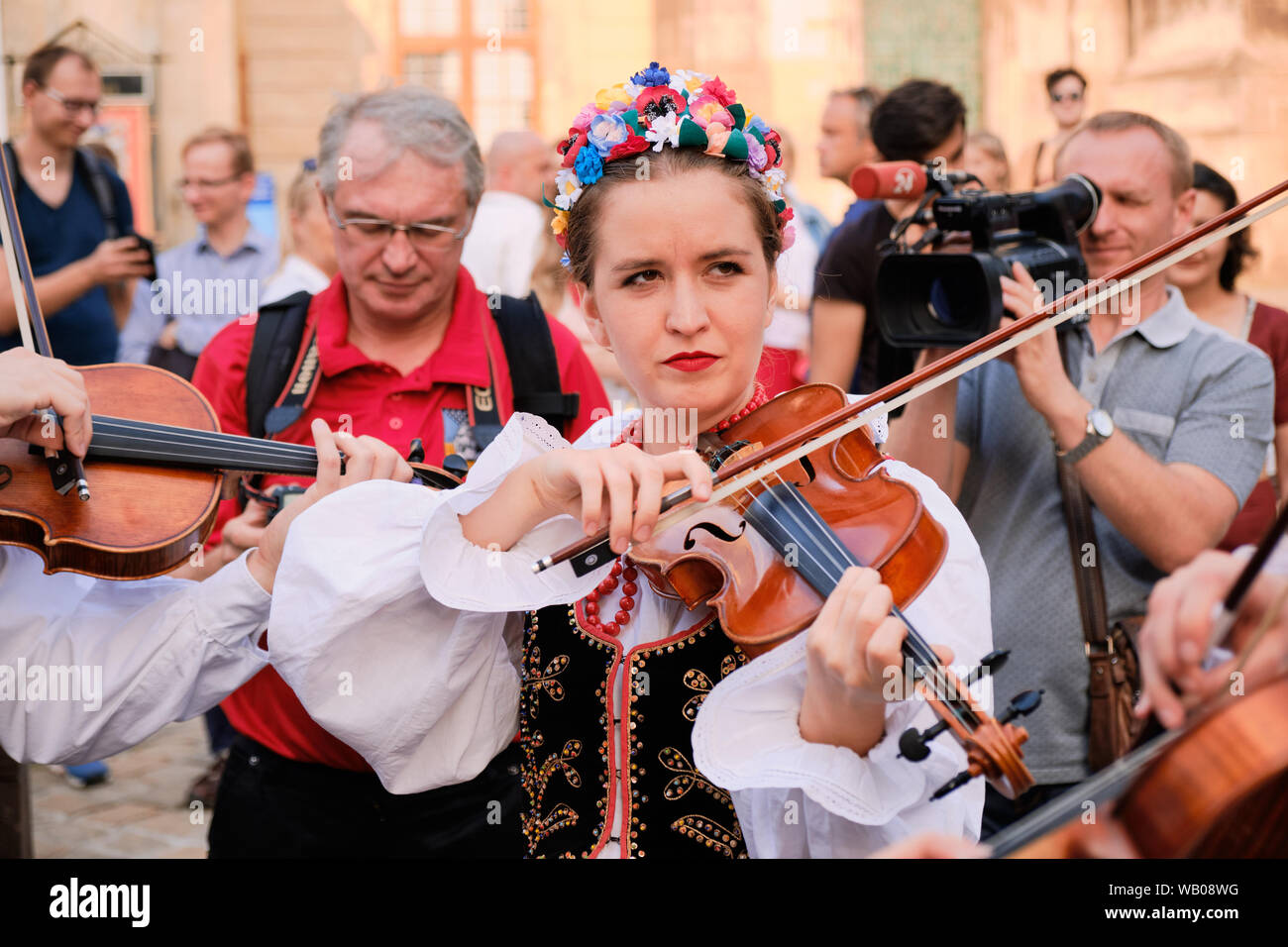 Polish Folklore group Marynia female violinist in spotlight performing number during Parade of Etnovyr Festival in street of Lviv.Ukraine - Stock Photo