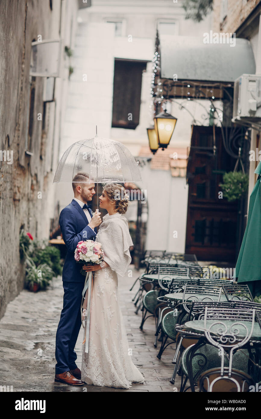 beautiful and elegant blonde bride in a long white dress with her ...