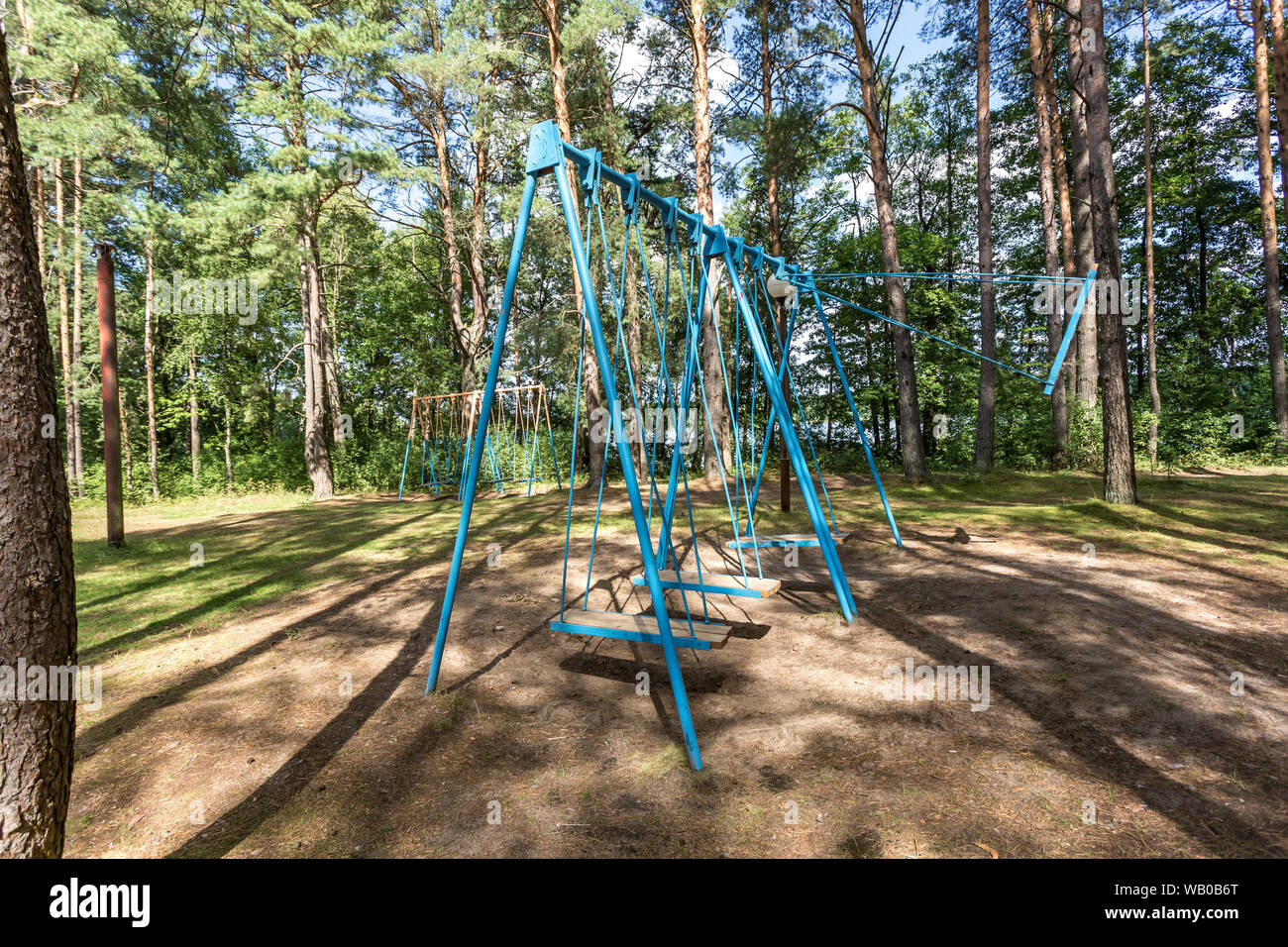 swing and horizontal bars on playground in pine forest Stock Photo Alamy