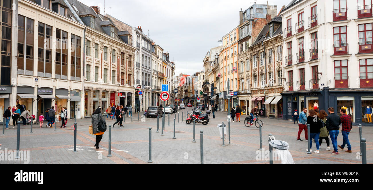 Panoramic view of shopping and sightseeing people along the Rue Esquermoise and Place du General de Gaulle with shops. Lille, France. Stock Photo