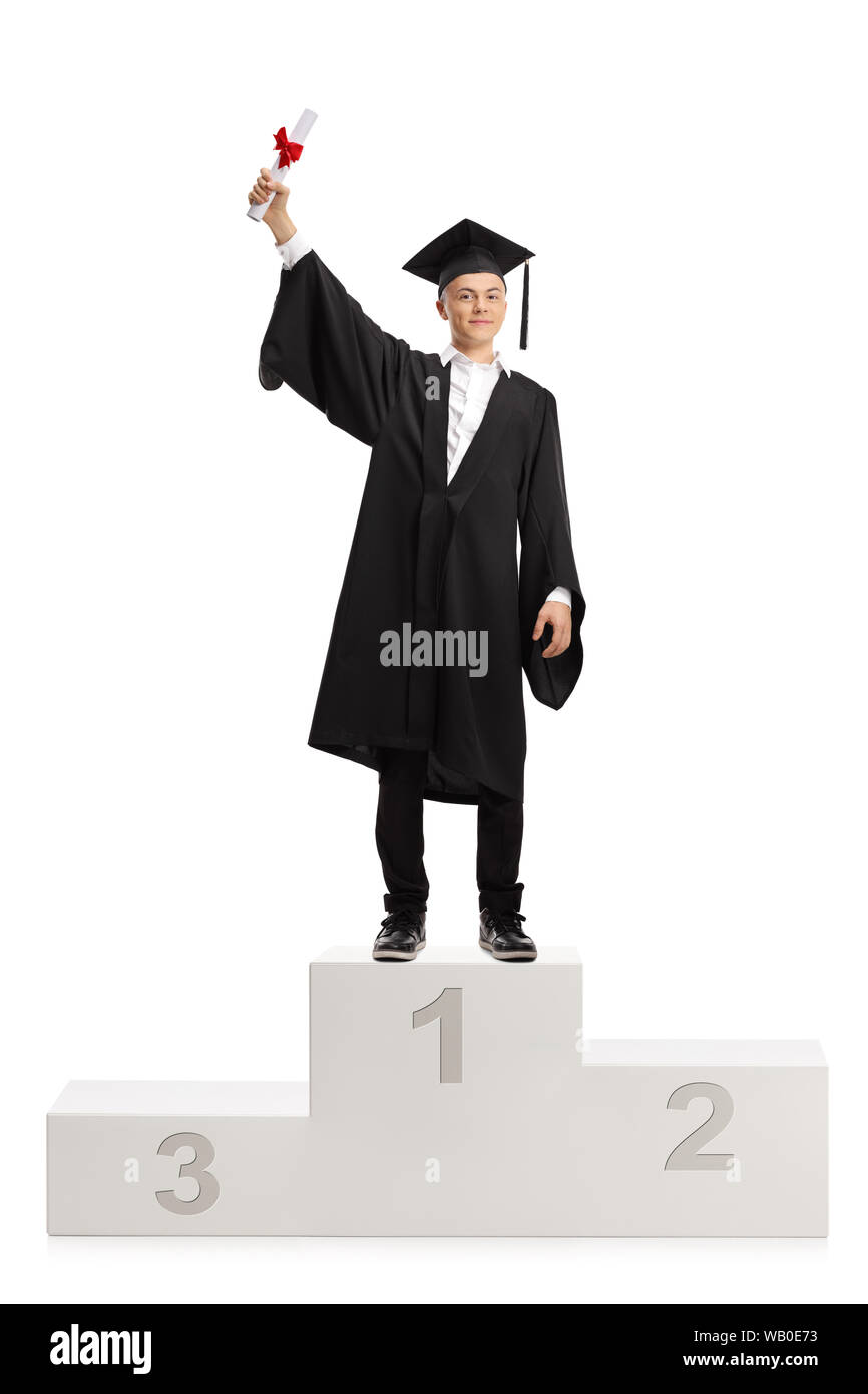 Full length portrait of a best male graduate student holding a diploma and standing on a winner's pedestal isolated on white background Stock Photo