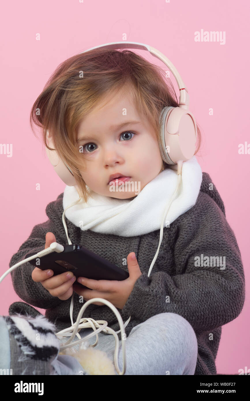 kid listen music with headset and mp3 on phone. having fun. winter kid  fashion. small happy girl. little girl child smiling. childhood and  happiness Stock Photo - Alamy