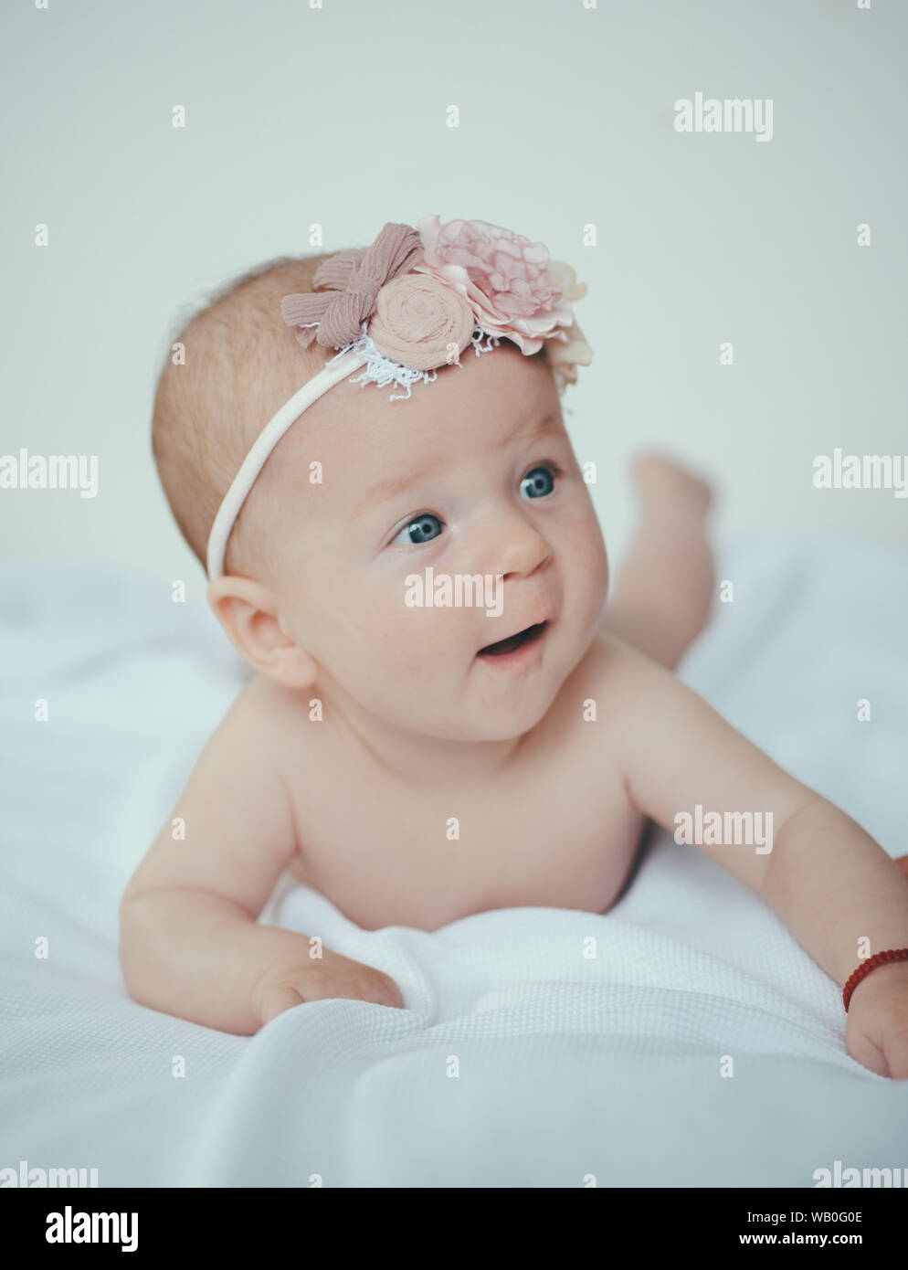 Newborn baby awake. Happy newborn in bedroom. Baby care routine. Choose