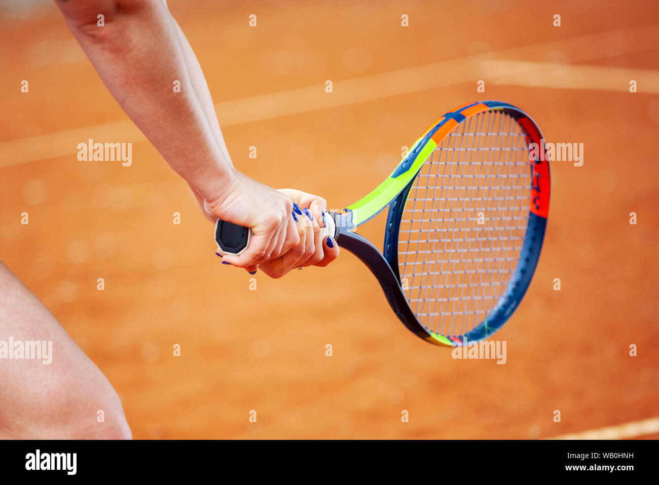 Close up female tennis player hitting two-handed backhand. Stock Photo