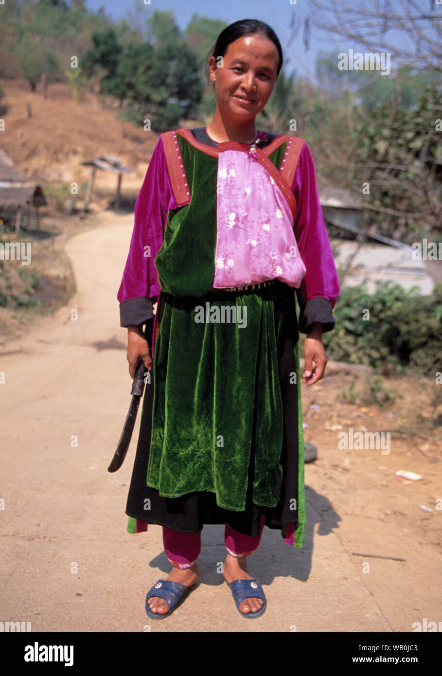 south east asian woman dressed in colourful clothes poses for the camera Stock Photo