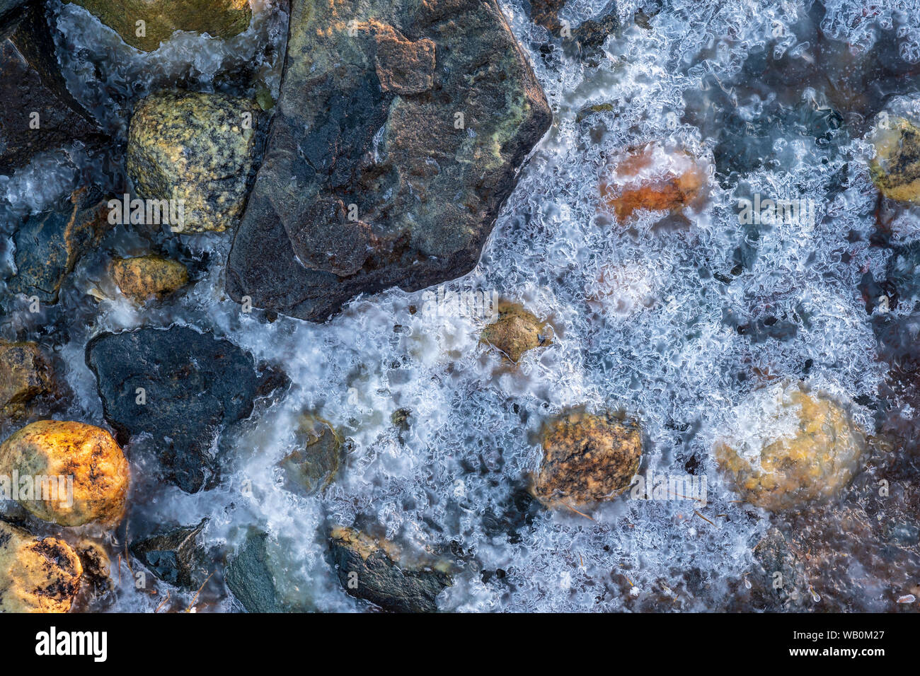 Structure of Ice and colorful stones on a beach in winter; Norway Stock Photo