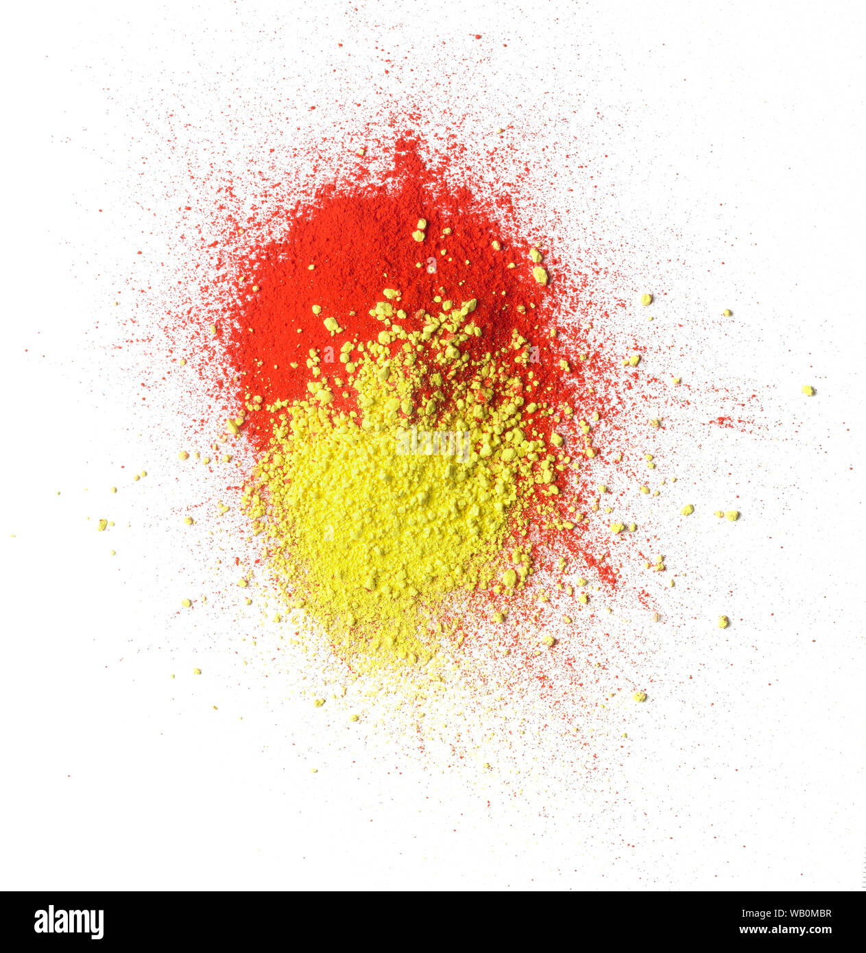 Red and yellow color powder heap against white background. Stock Photo