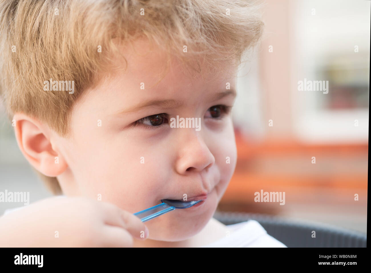 Kids haircut with style. Little child with short blond hair. Healthy hair  care habits. Little child eating outdoor. Small boy with stylish haircut.  Ta Stock Photo - Alamy