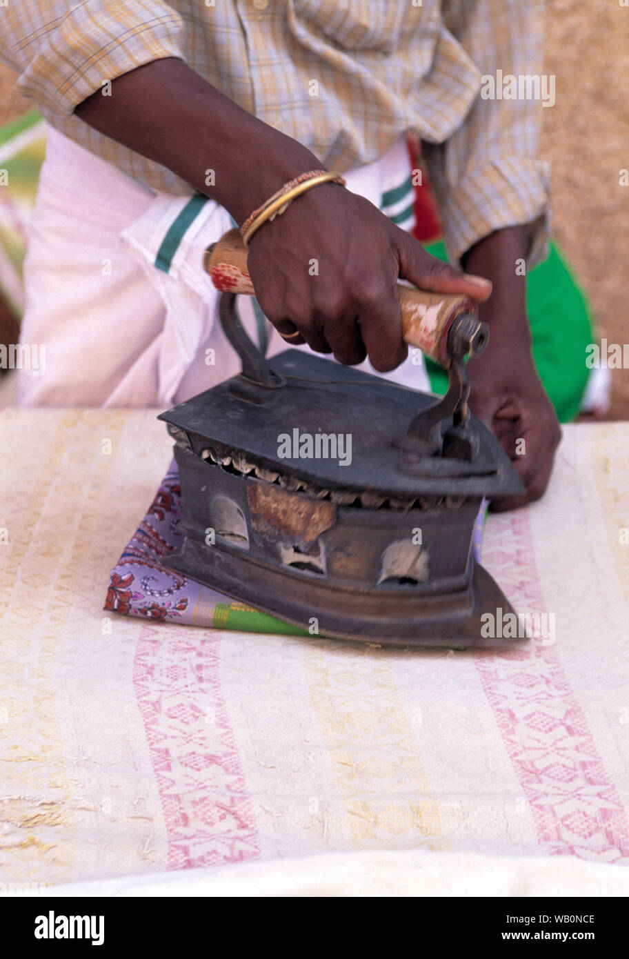 asia, asian, india, woman ironing cloth with an old fashioned metal iron Stock Photo