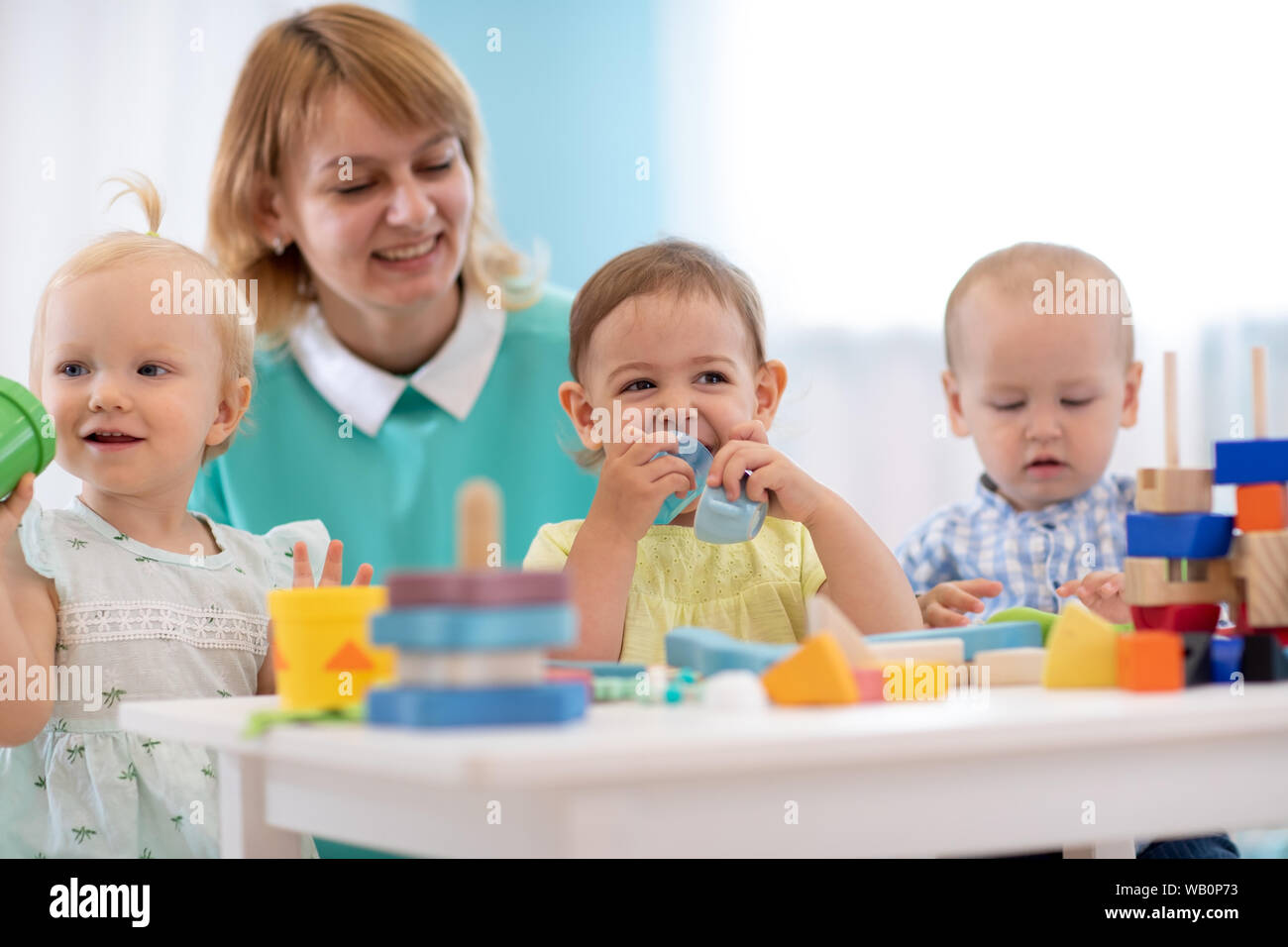 Nursery kids play with educational toys in classroom. Kindergarten ...