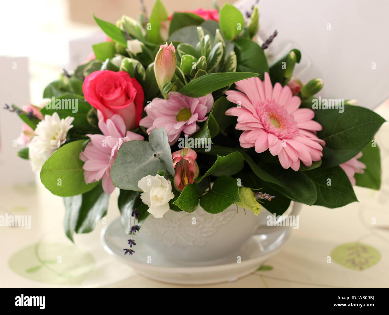 Bouquet of pink flowers in a large cup Stock Photo