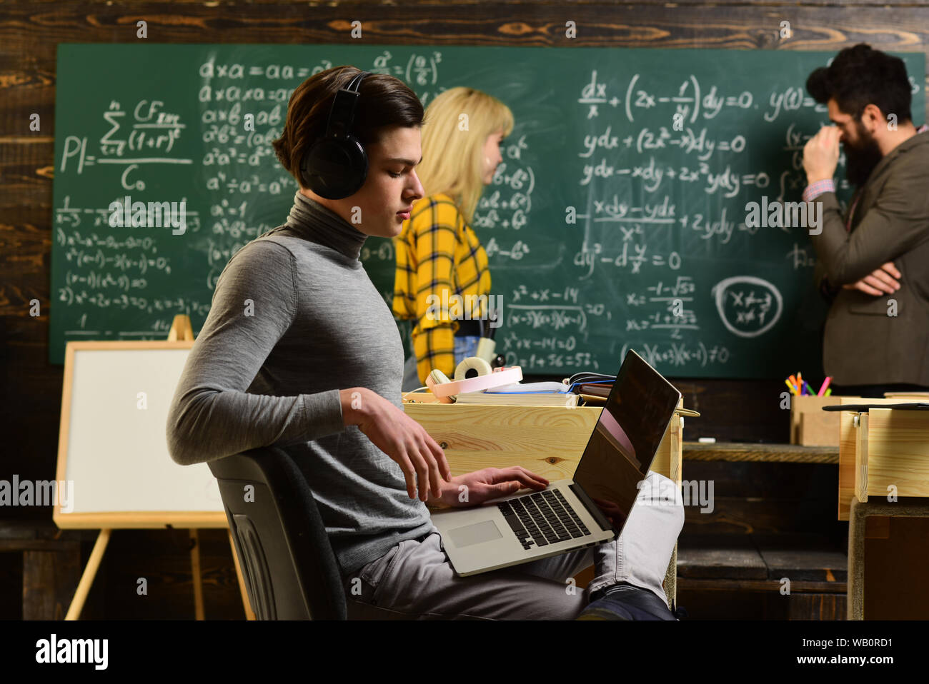 Students studying and testing lesson from teacher in classroom at ...
