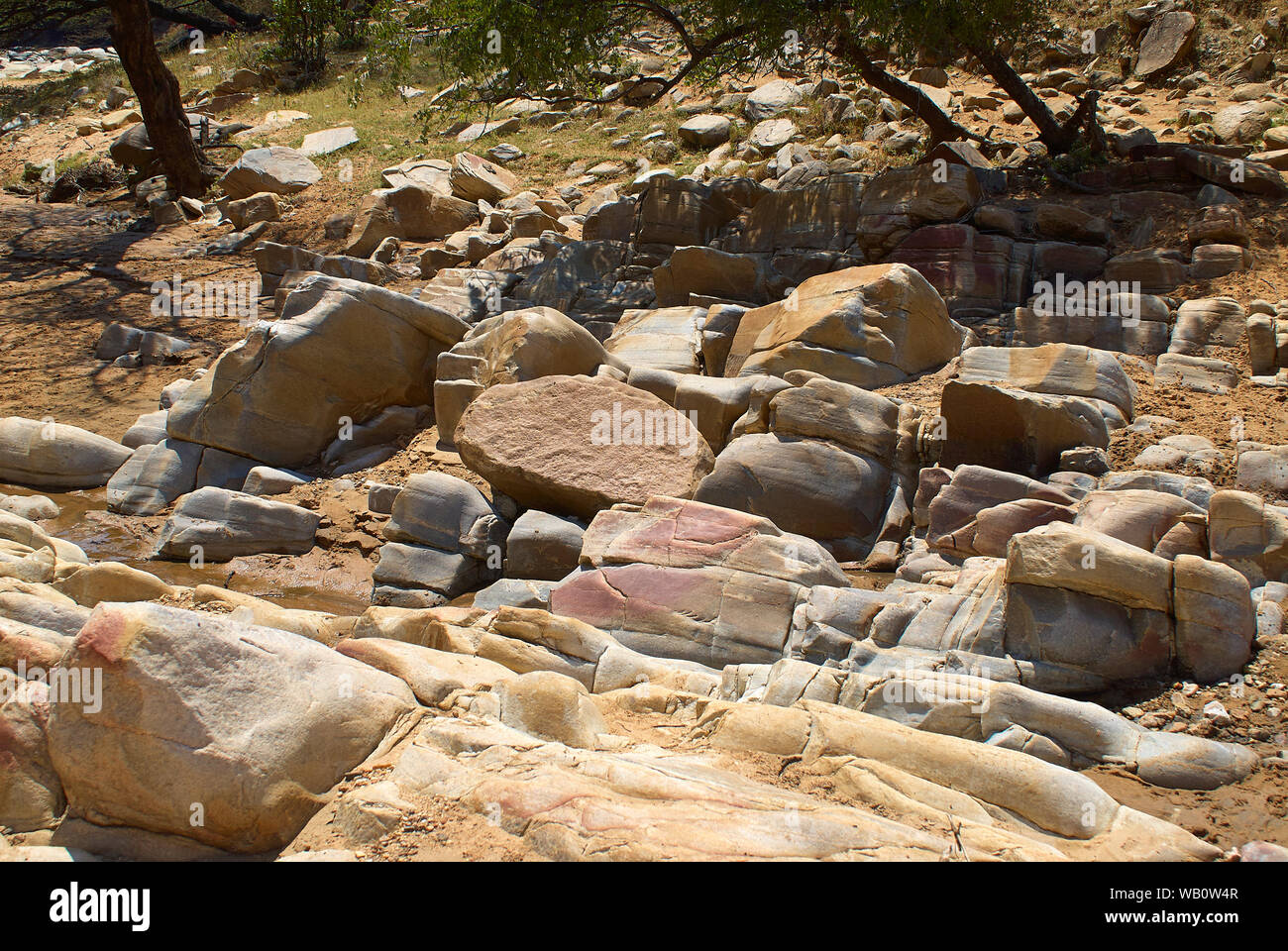 A dry riverbed with shifted layers of rock Stock Photo - Alamy