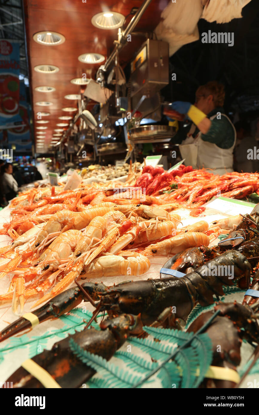 Fresh shellfish on the market desk. Lobsters, langoustine, shrimps, nephrons, prawns Stock Photo