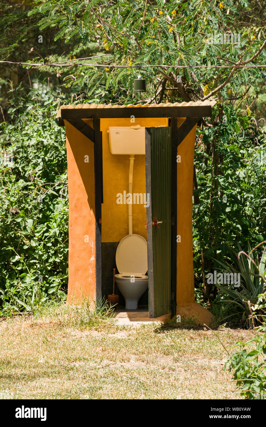An outdoor camp site toilet with corrugated green door, Kenya, East Africa Stock Photo