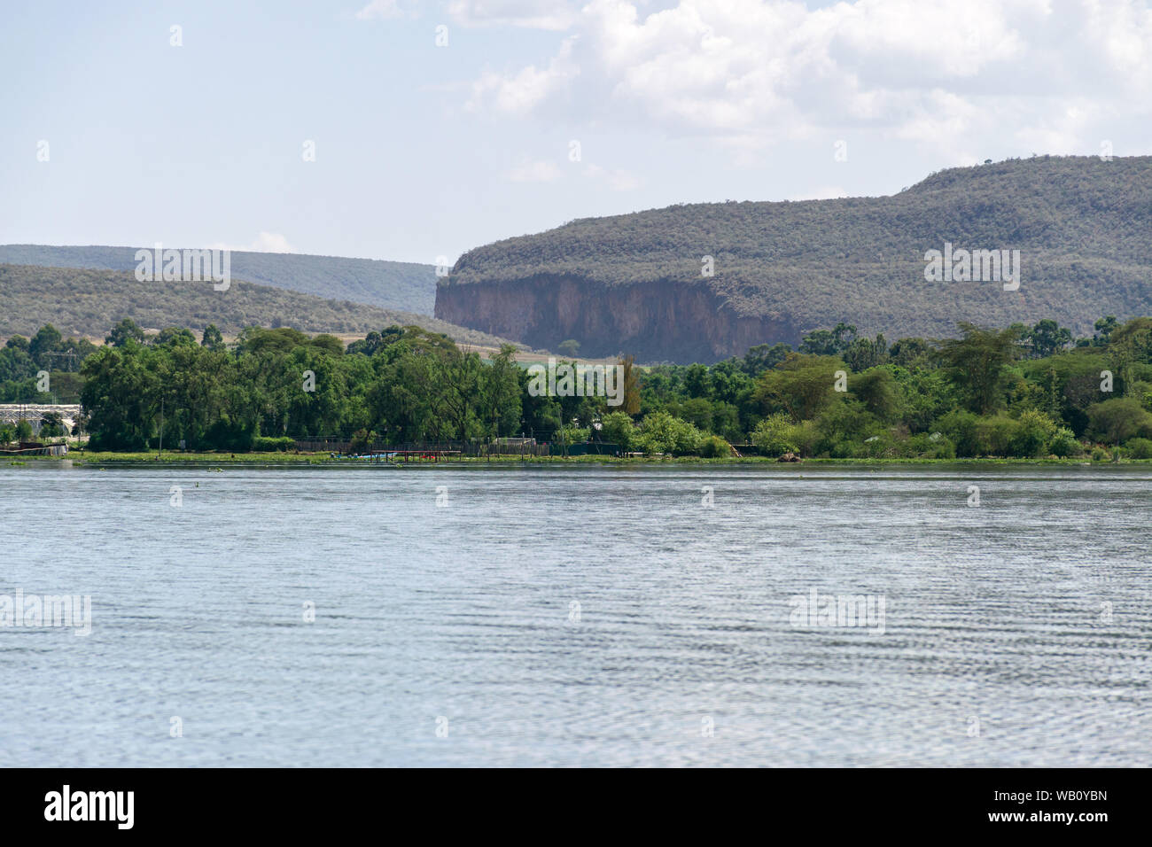 Lake Naivasha shoreline with Hell's Gate National Park hills in background, Kenya Stock Photo