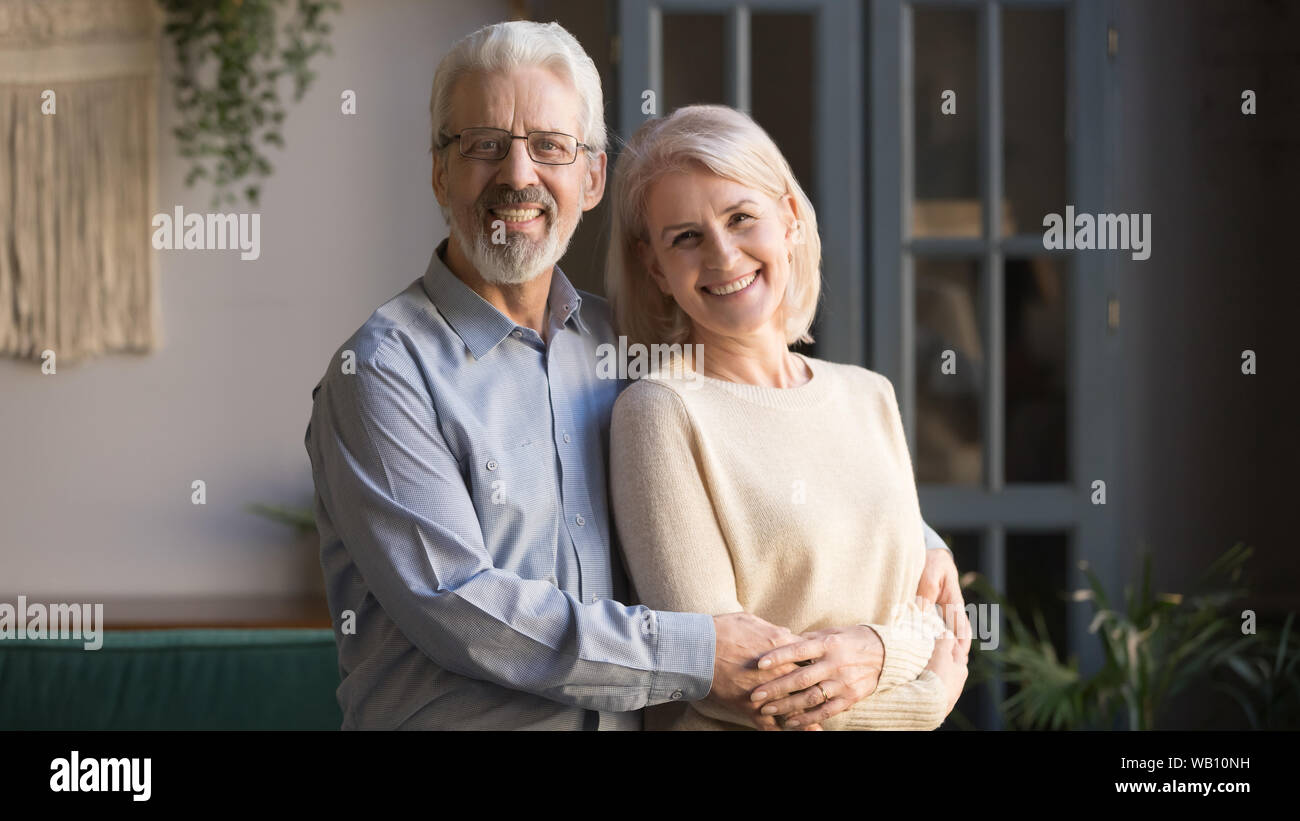 Happy old senior retired family couple bonding posing for portrait Stock Photo
