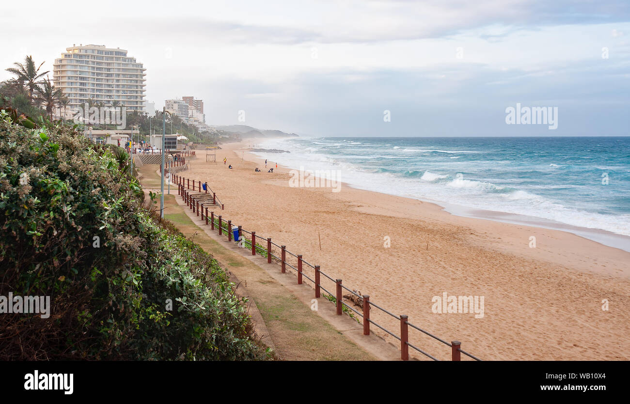 DURBAN SOUTH AFRICA - AUGUST 13 2019: People walking on the beach and promenade at the beach in Umhlanga Rocks near Durban KwaZulu-Natal South Africa Stock Photo