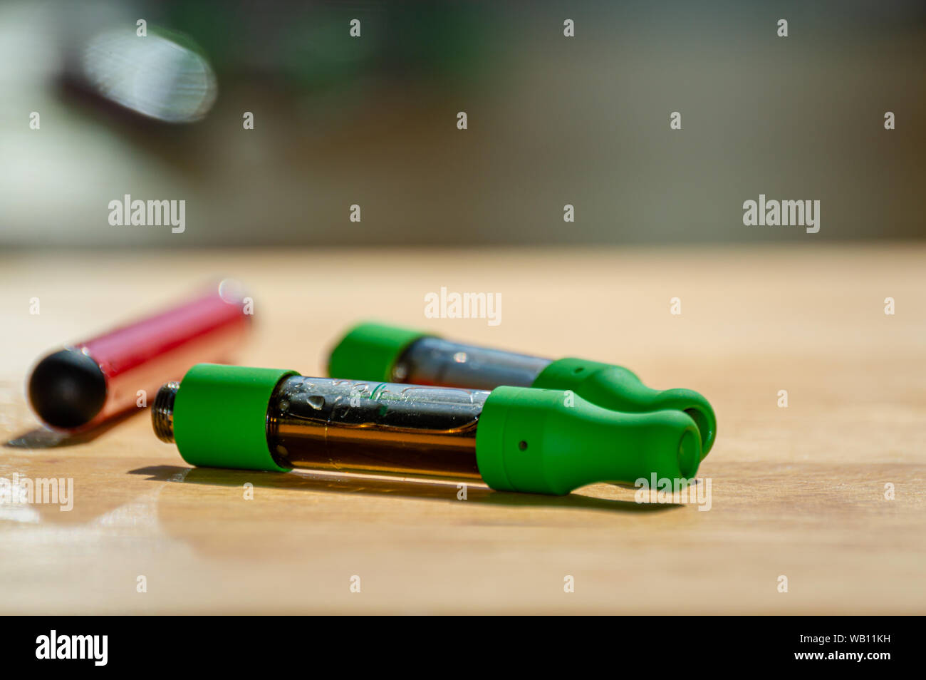 Marijuana vape kit with red vape pen and THC CBD oil cartridges. Stock Photo