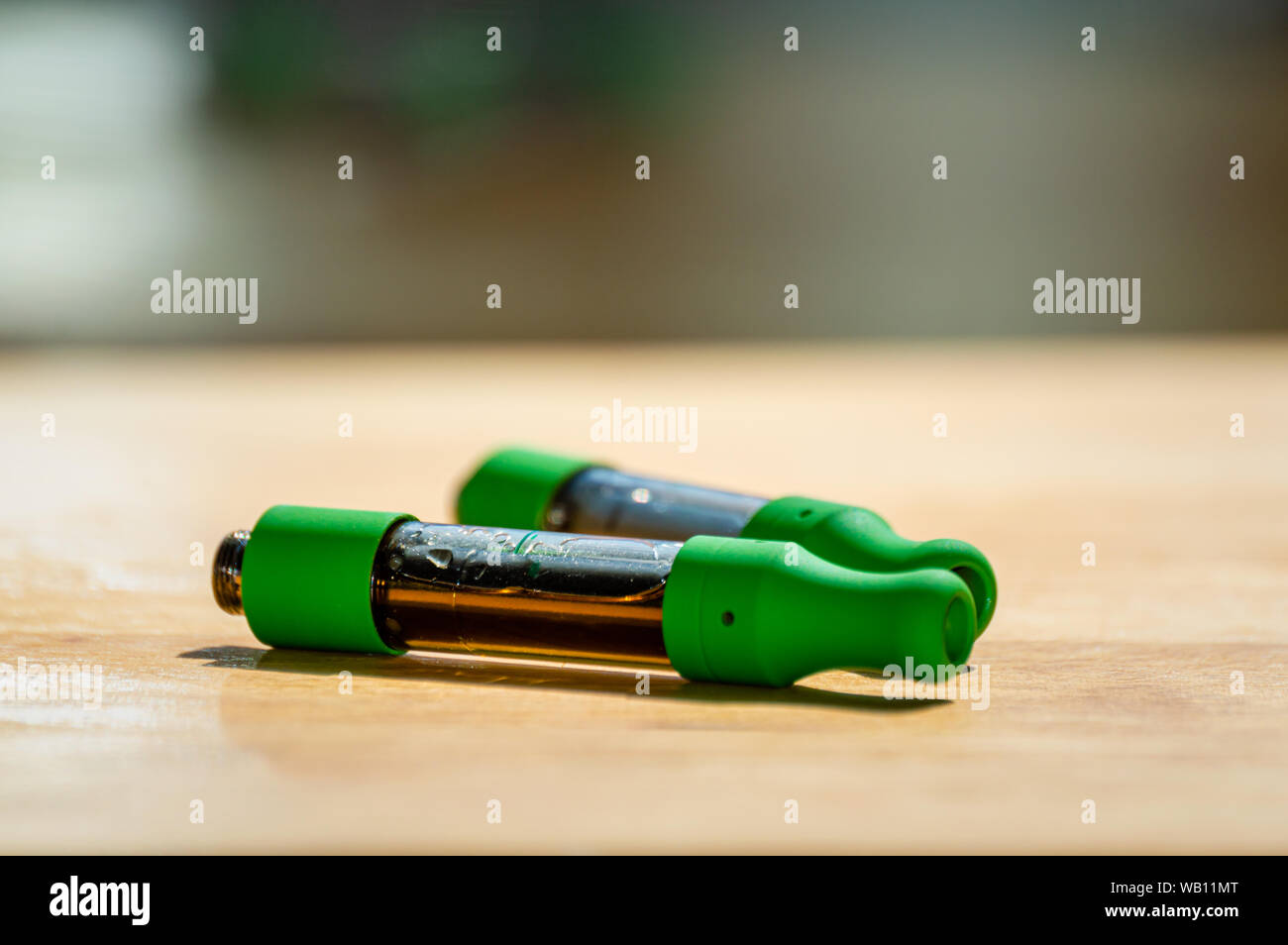 Close up of two marijuana THC CBD oil cartridges for vaping. Stock Photo