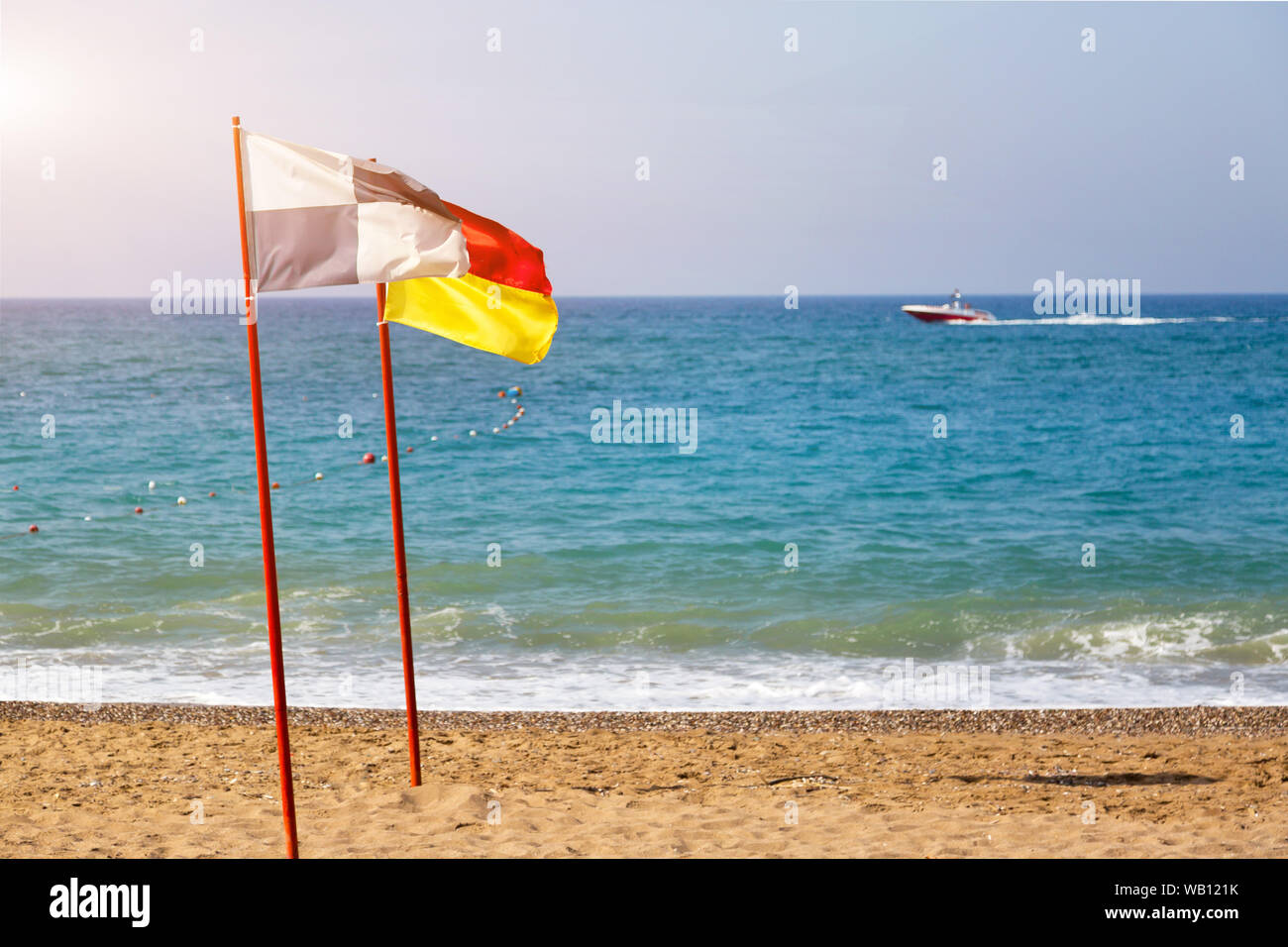 Blackwhite and redyellow flags on beach coast Stock Photo Alamy