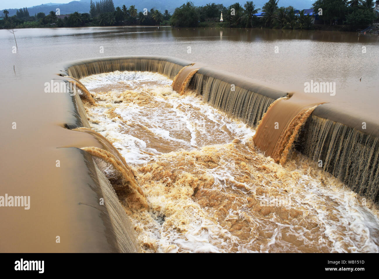 Turbid water in the dam overflows into the spillway , Thailand Stock